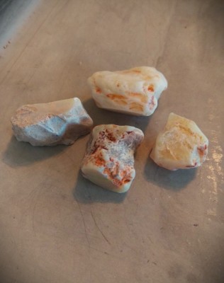 Most of the Coober Pedy white rough I'm able to get looks similar to this.  Size wise they're about an inch long and wide, so maybe 4-5 grams, or 20-25 carats or so.  regular room light, no magnification.  a lot of times I really gotta look for the color, get the stone wet and use magnification....and my expectations always need to be managed...lol...