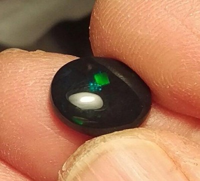 An N1 Black Opal with green play of color...fairly common for Black Opal